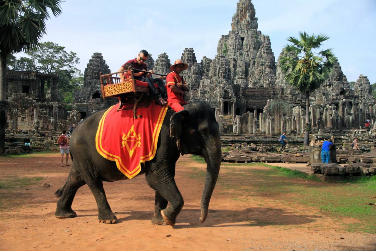 Tourists riding an elephant in Angkor Wat, Cambodia